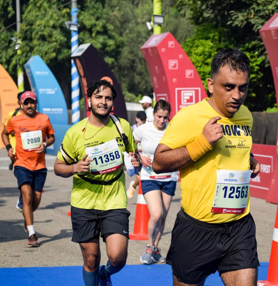 New Delhi, India - October 16 2022 - Vedanta Delhi Half Marathon race after covid in which marathon participants about to cross the finish line, Delhi Half Marathon 2022 photo