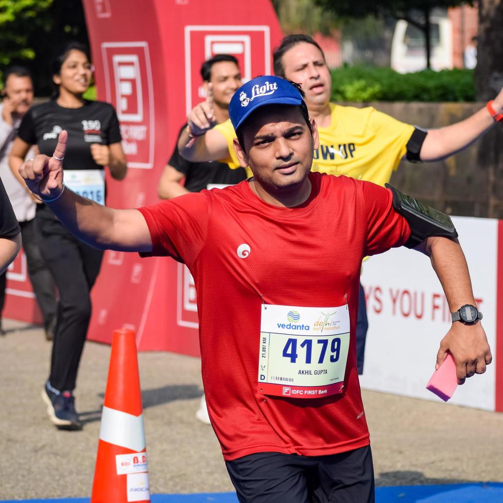 New Delhi, India - October 16 2022 - Vedanta Delhi Half Marathon race after covid in which marathon participants about to cross the finish line, Delhi Half Marathon 2022 photo