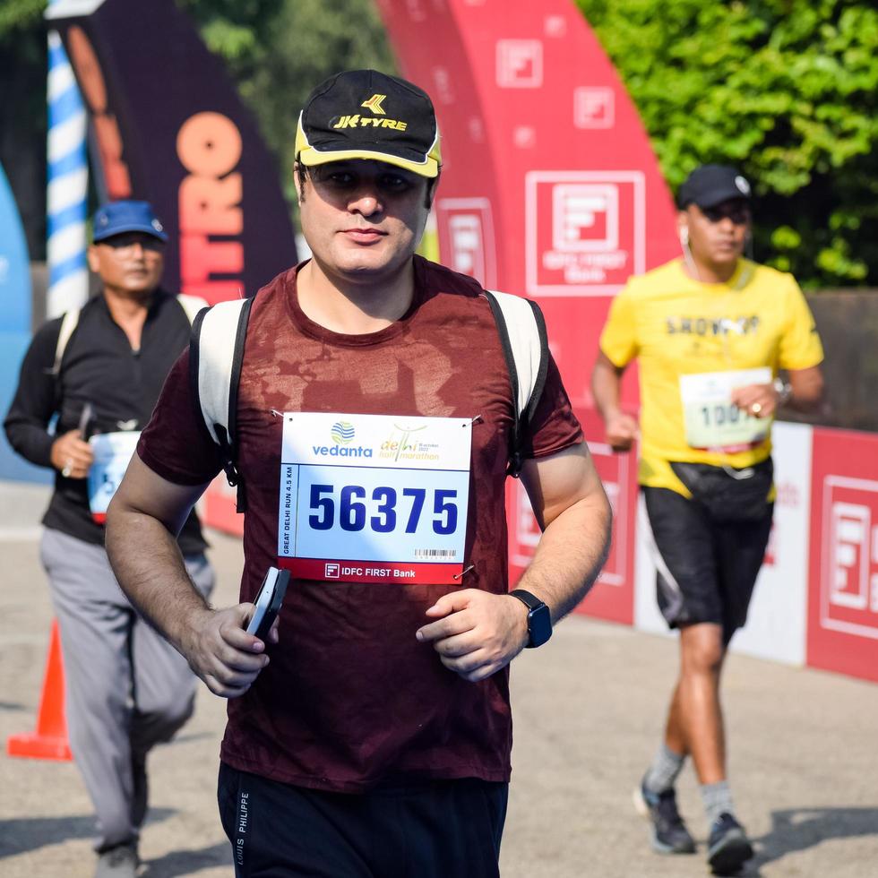 New Delhi, India - October 16 2022 - Vedanta Delhi Half Marathon race after covid in which marathon participants about to cross the finish line, Delhi Half Marathon 2022 photo