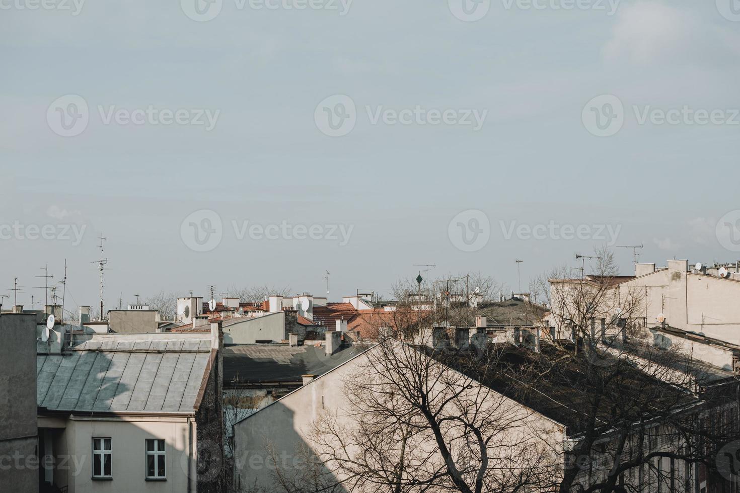 Roofs of the apartment houses in Poland city of Krakow during the sunny winter day photo