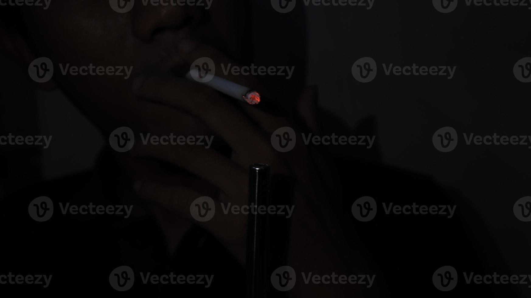 Smoker Lighting a Cigarette with a Gas Lighter. photo