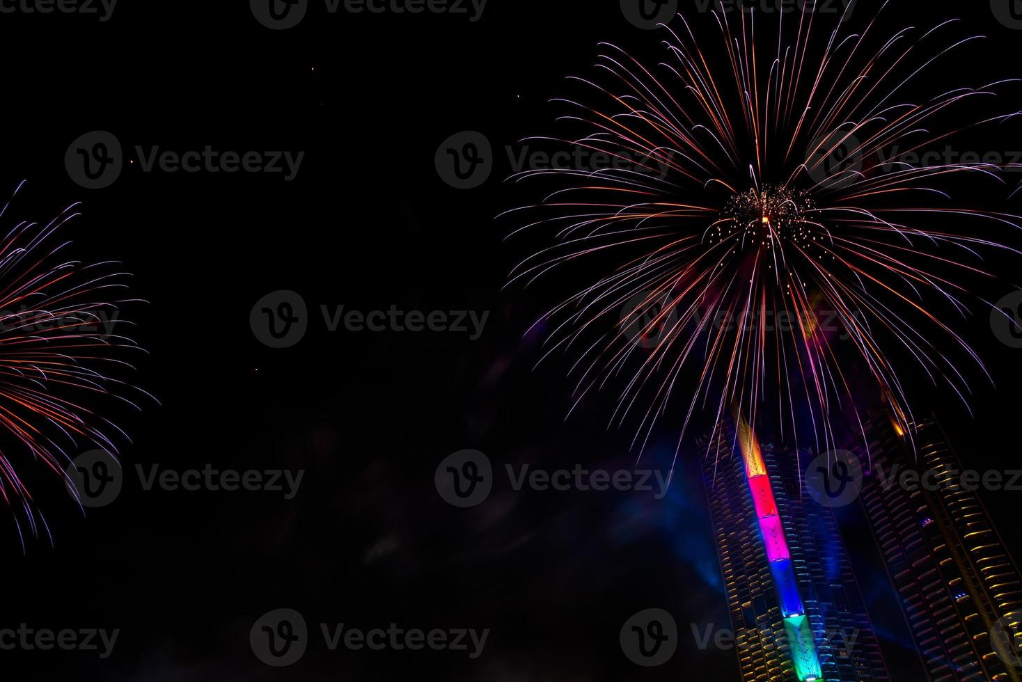 New year celebrate,  crowd and colorful fireworks near the river, Thailand photo