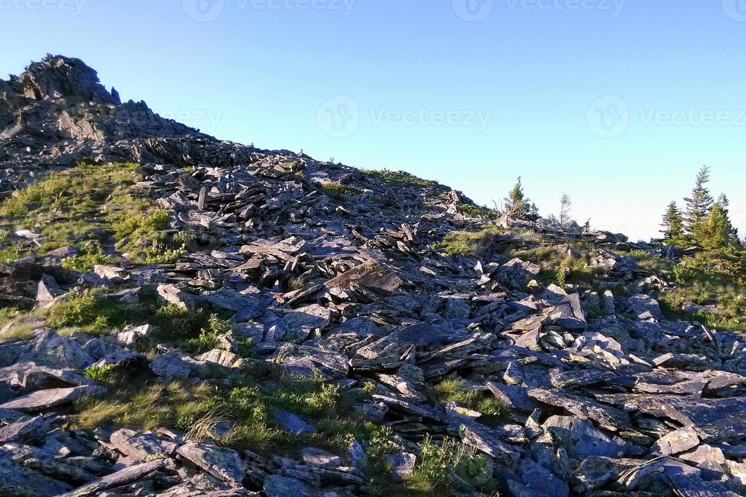 Travel to Ural mountains, Russia. The view from a peak on the mountains, forest and cloudy sky. photo