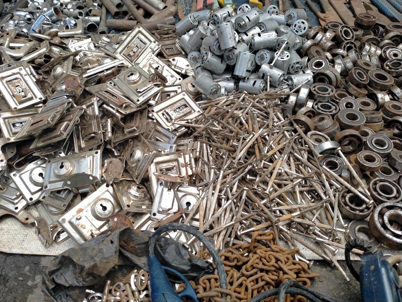 Many metal grey hard internal thread for thin units on the upper left part of oblong horizontal, top view on background of black grunge rustic surface . photo