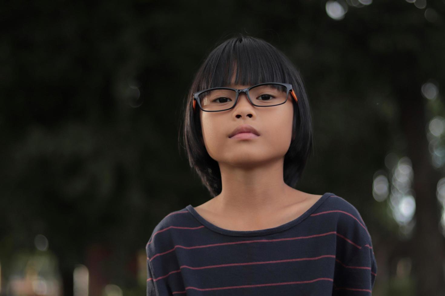 Portrait of child wearing eyeglasses with blur background. photo