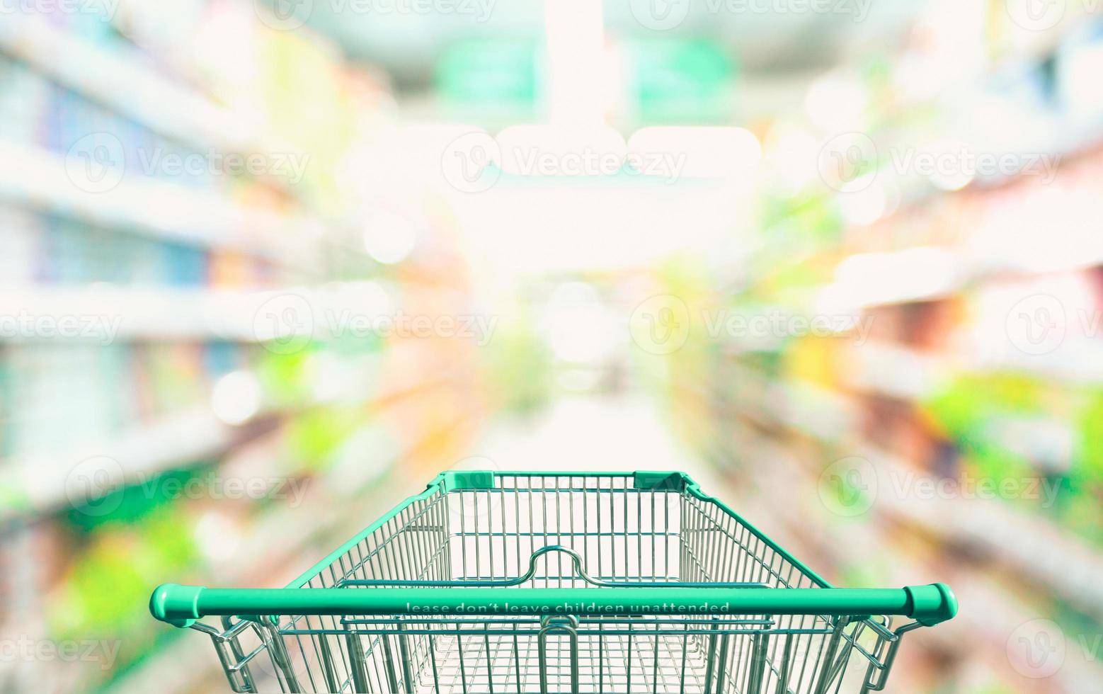 Shopping cart in supermarket and blurred photo store bokeh background