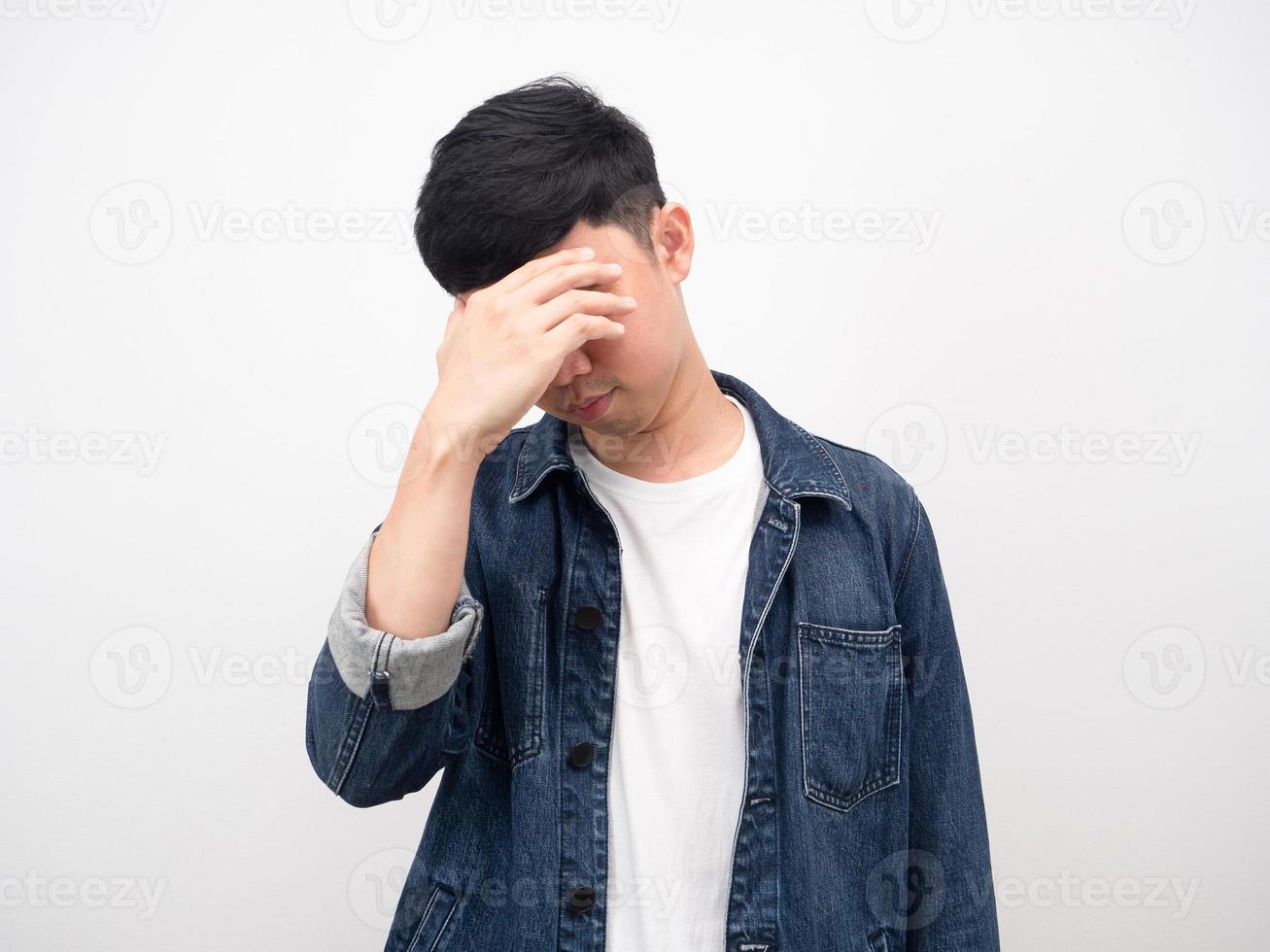 Man jean shirt hold the hand at head headache and strain photo