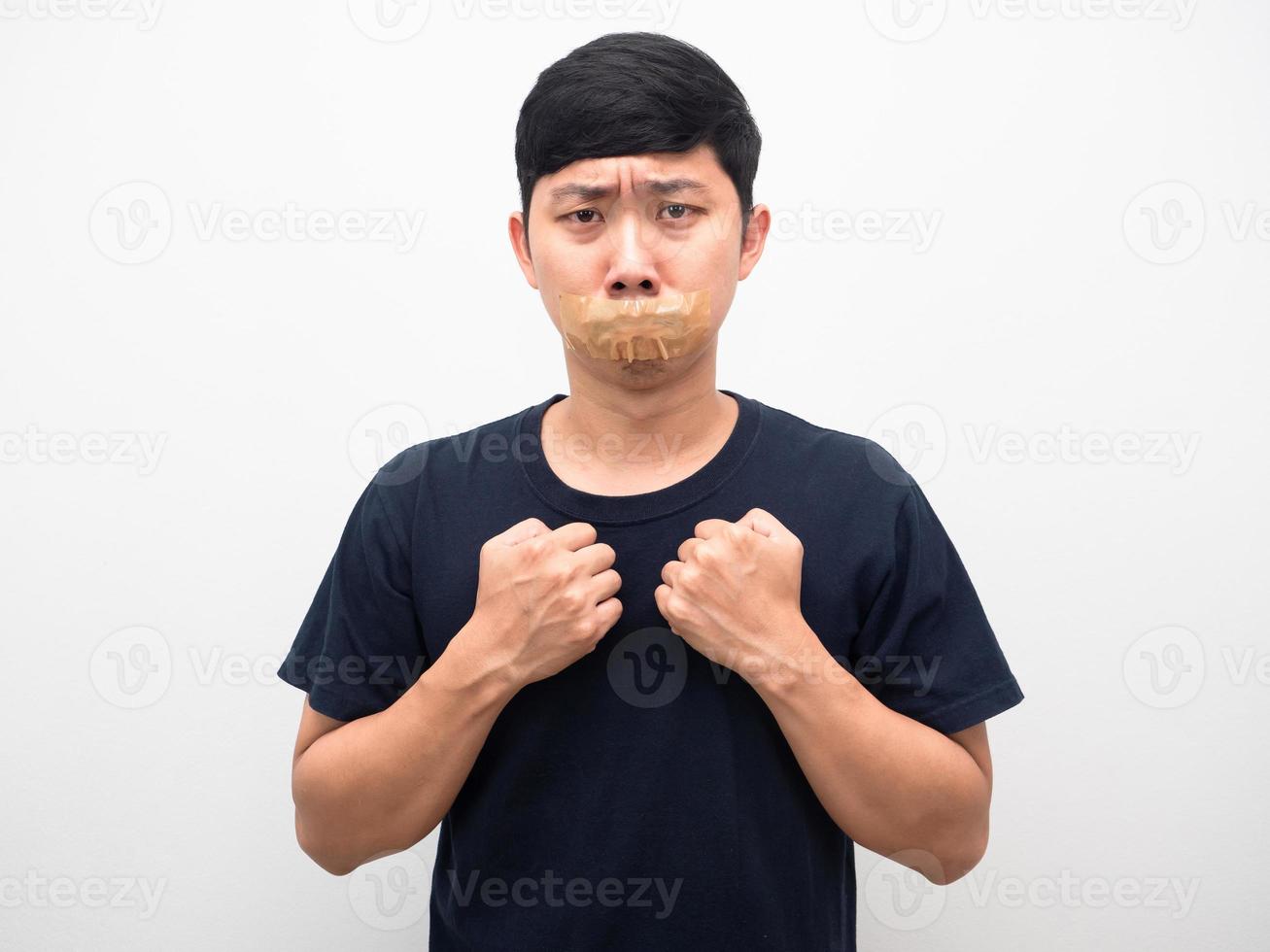 Man afraid with tape close mouth for quiet and don,t speech photo