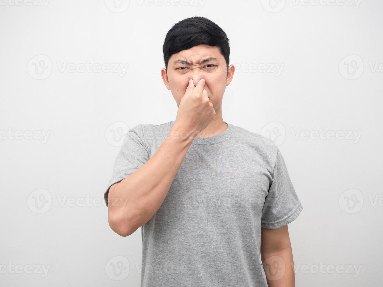 Man feeling smelly close his nose portrait white background photo