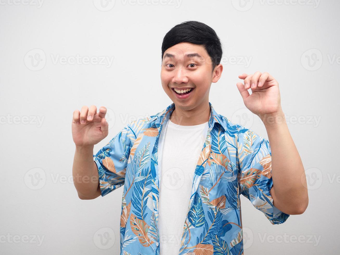 Asian man blue shirt happy emotion dancing about holiday photo