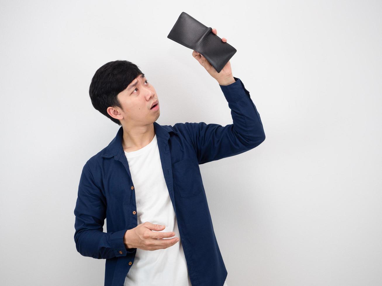 Man looking for money at his wallet sad at face poor man concept on white background photo