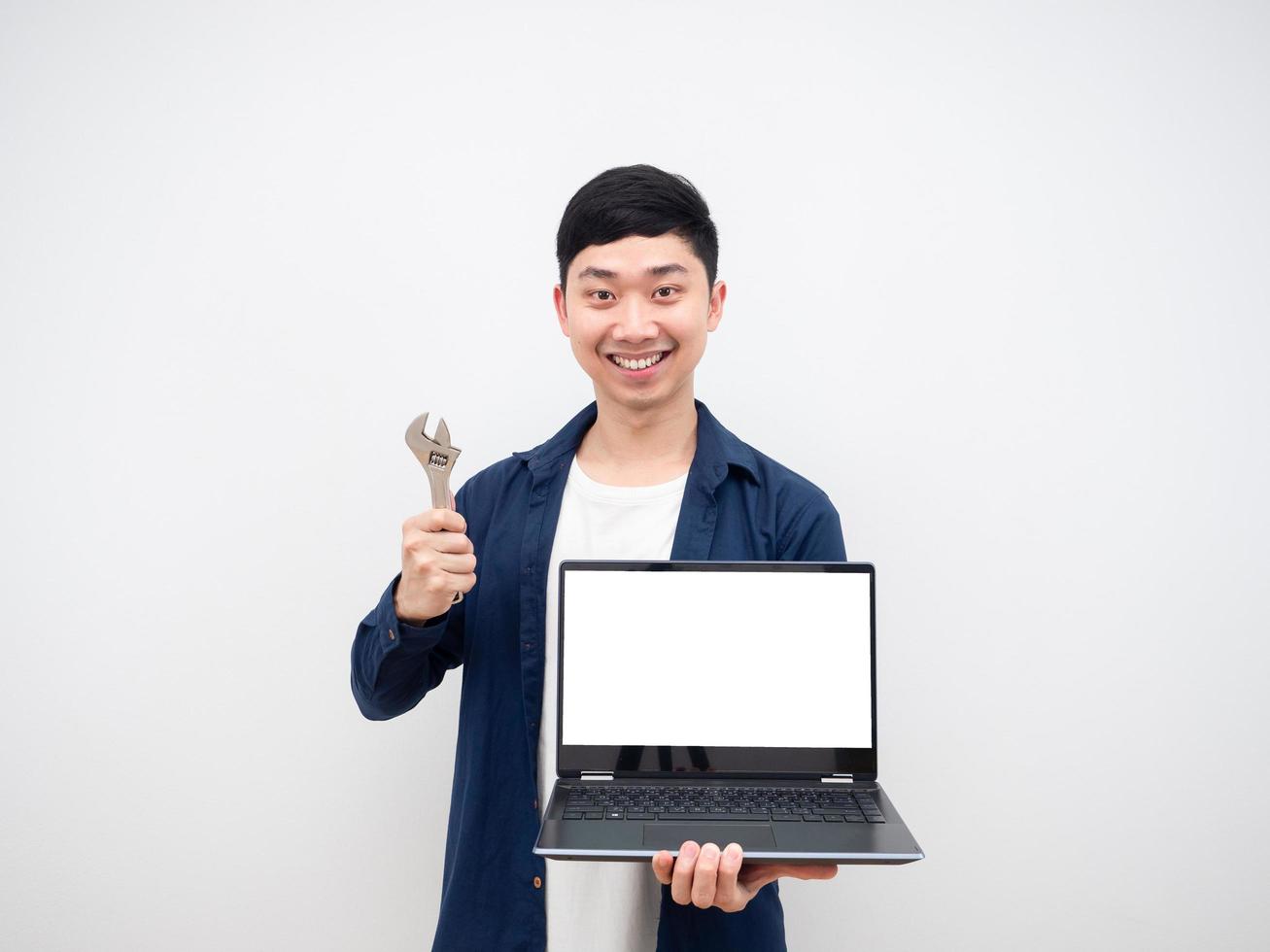 Asian man cheerful hoding laptop and adjustable wrench fixed and repair concept on white background photo