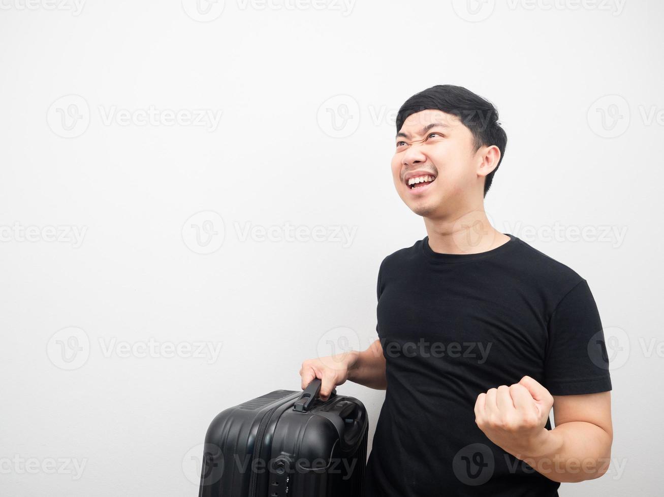 Man holding luggage gesture happy looking at copy space photo