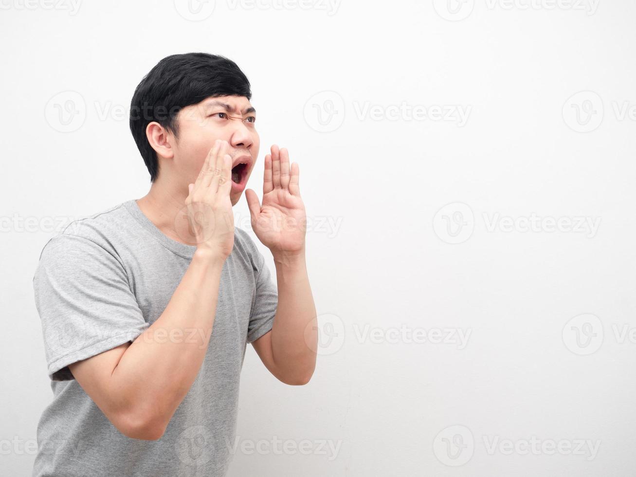 Asian man gesture shout serious face looking at copy space photo