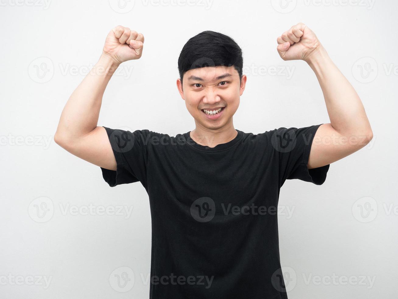 Asian man show fist up for success confident face photo