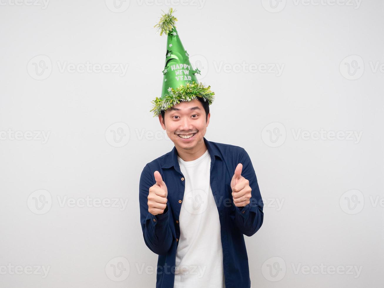 Cheerful man wearing green hat thumb up white background photo