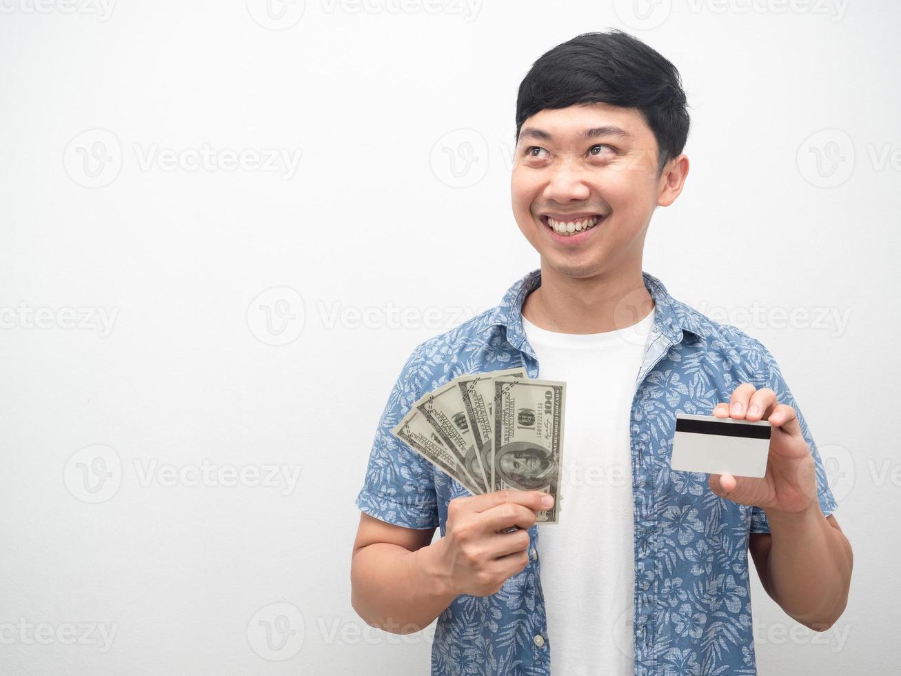 Asian man holding credit card and money happy smile looking at copy space photo
