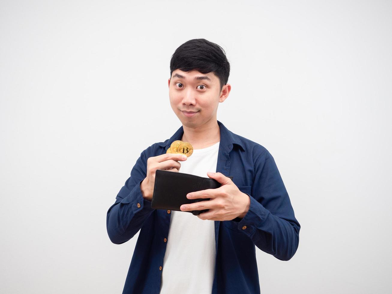 Asian man happy face pick up gold bitcoins from his wallet on white background digital money concept photo