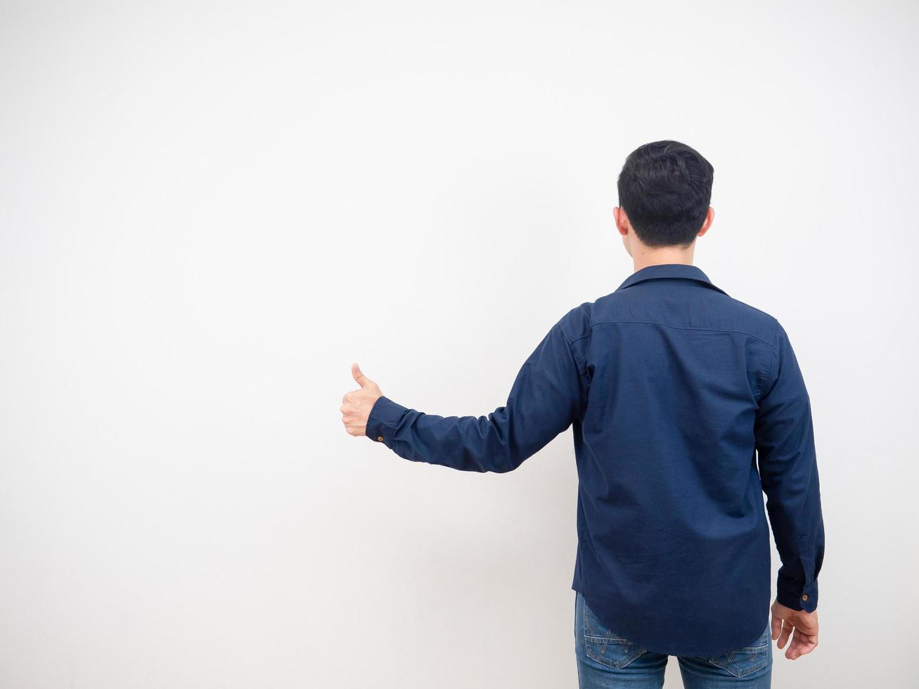 Back view of man jean suit show thumb up copy space white background photo