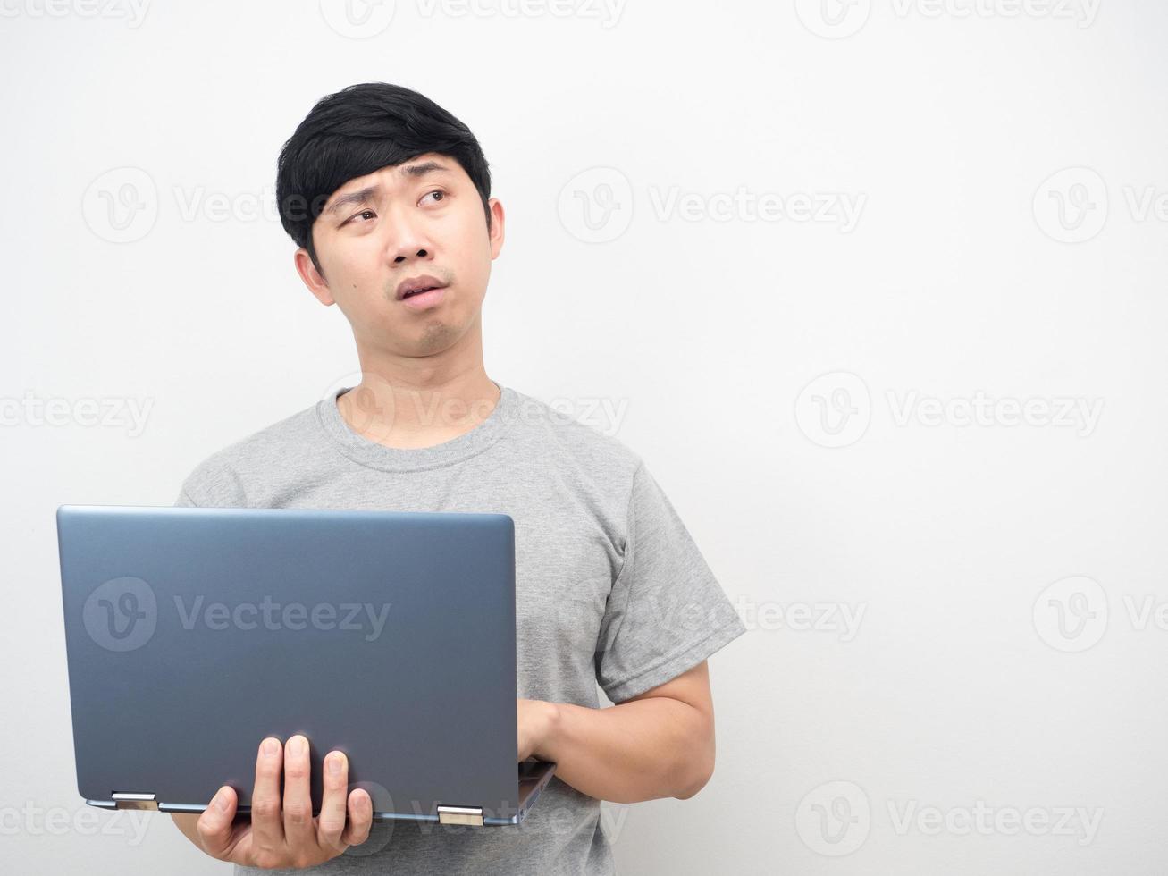 Man using laptop feeling tried and bored looking at copy space photo