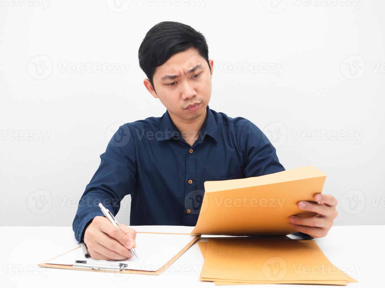 Man working at his workplace looking at document in hand feeling serious and strain white backgound photo