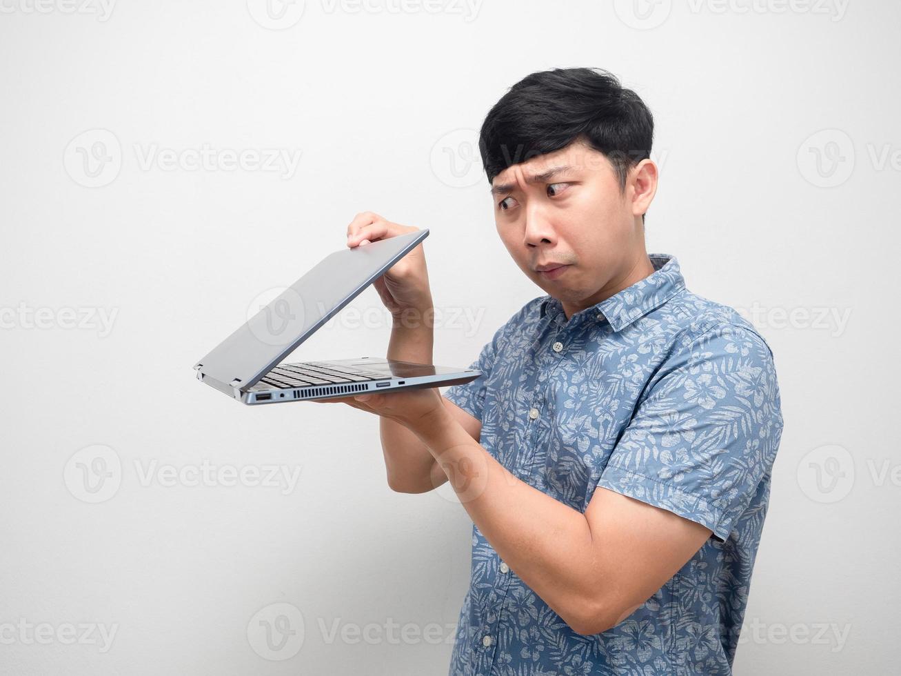 Man blue shirt half open laptop in hand gesture spying content photo