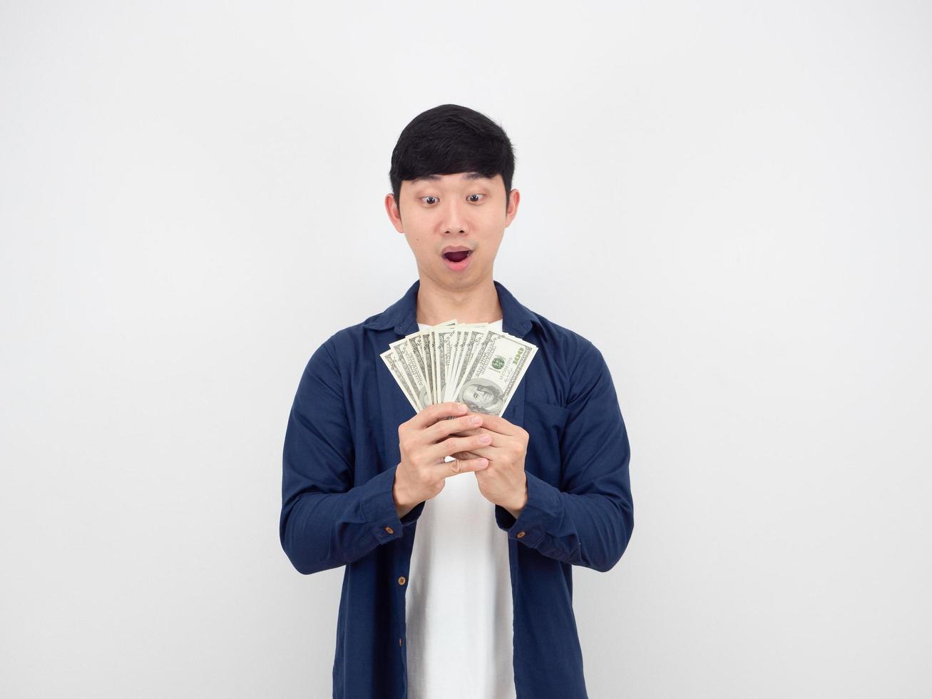 Man looking at A lot of money in his hand feeling amazed say wow on white background photo