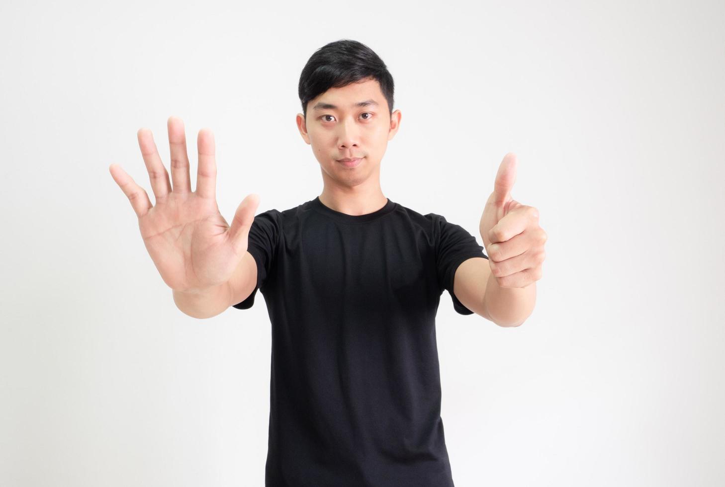Young Asian man black shirt count one to ten by hand half body on white isolated background,Man counting number concept photo