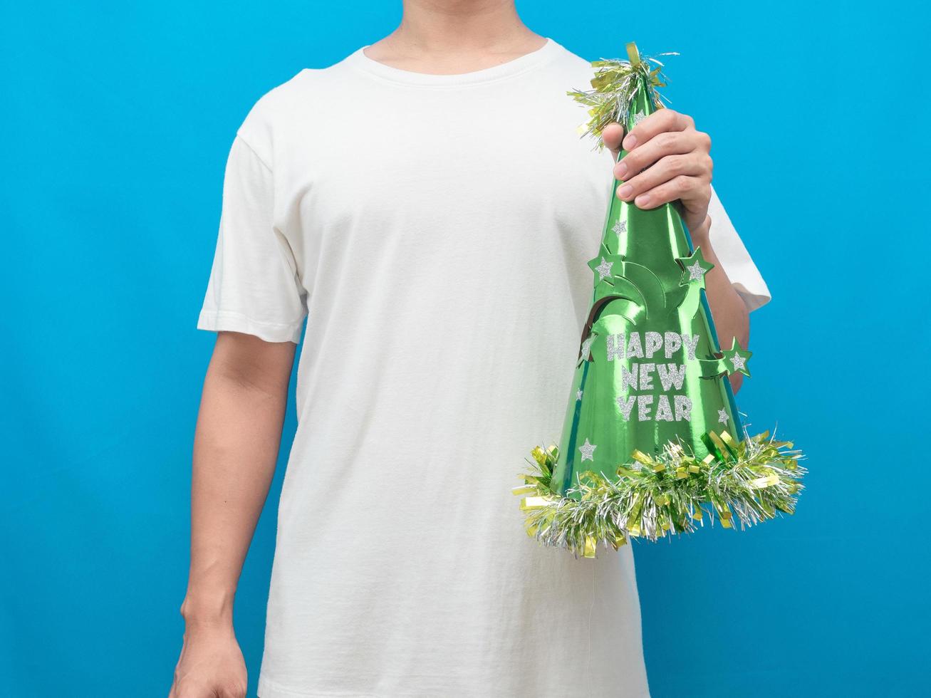 Man holding happy new year hat green color blue background photo