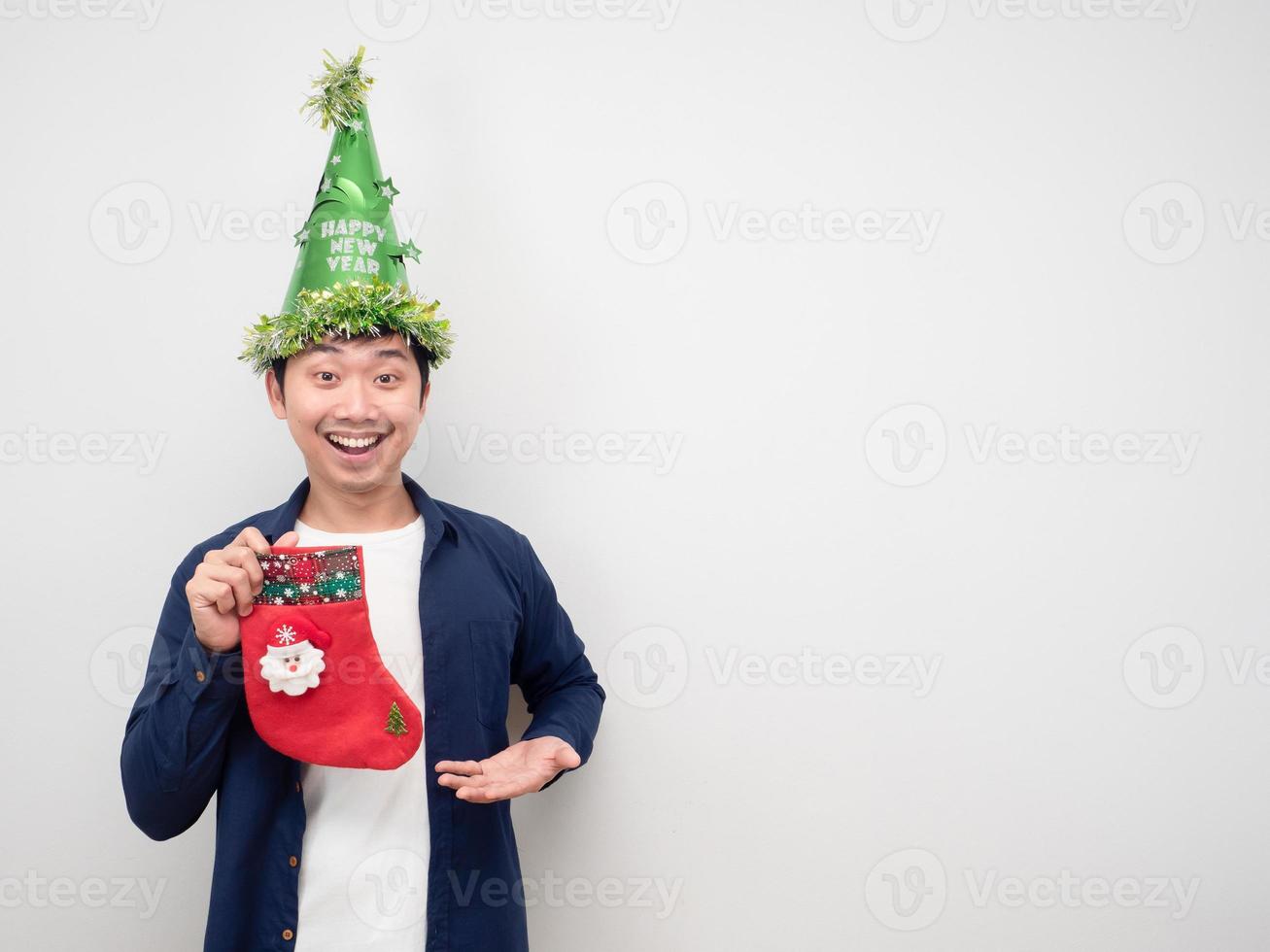 Man wearing gree hat nad holding christmas stocking feeling happy emotion copy space photo