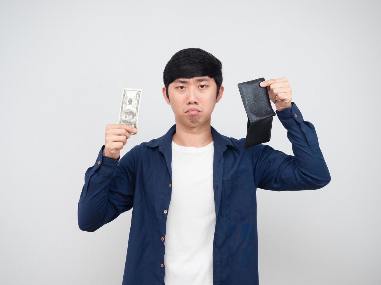Asian man holding money dollar and wallet sad face white background poor man concept photo