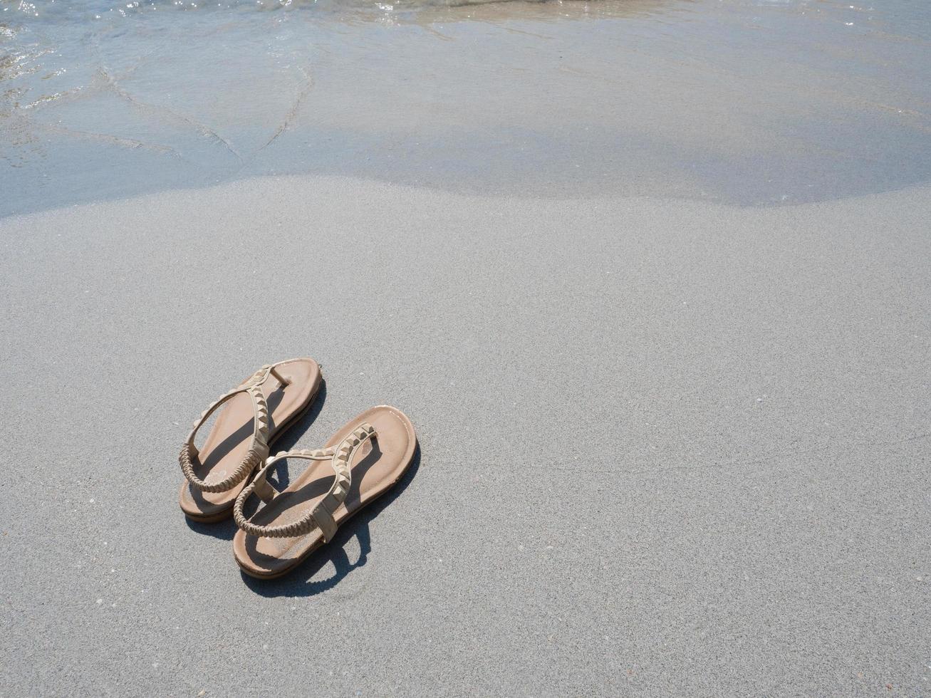 Woman shoe on the beach copy space top view photo