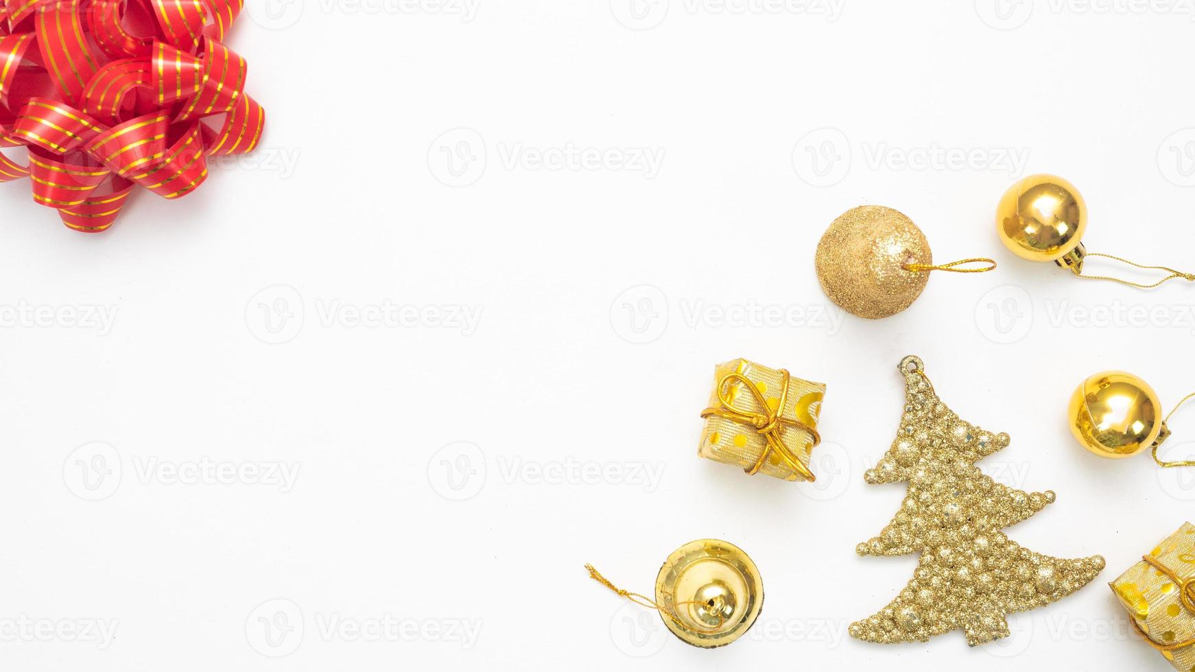 Golden christmas accessories  and red ribbon on white background top view copy space photo