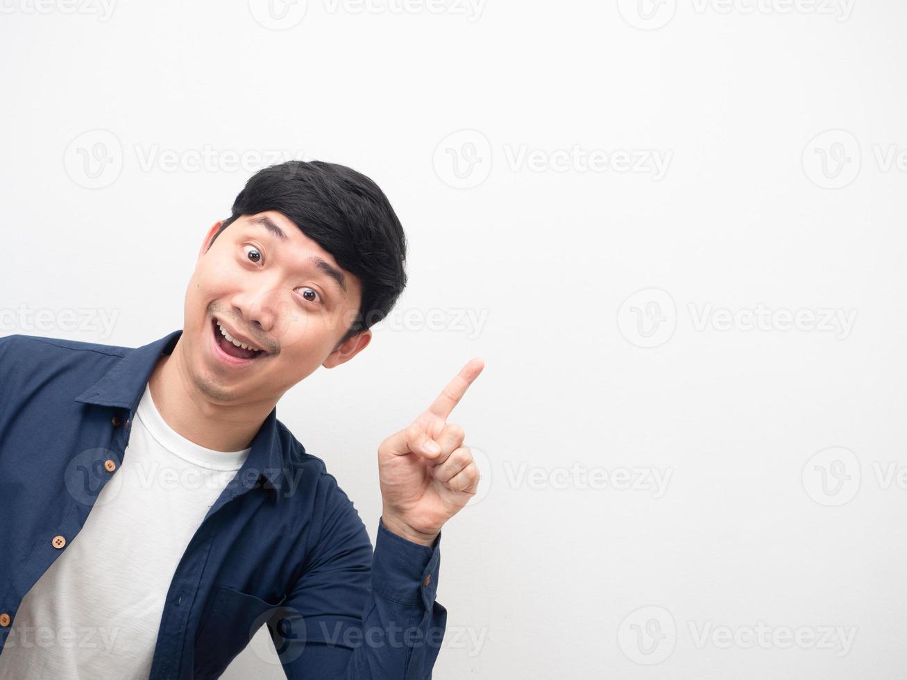 Cheerful man gesture point finger at copy space photo