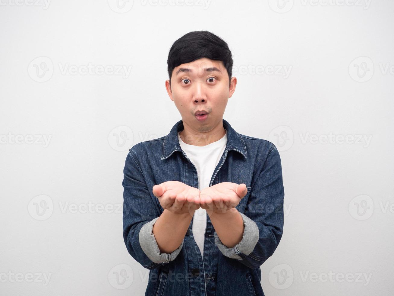 Asian man showing empty hand up feeling excited copy space photo