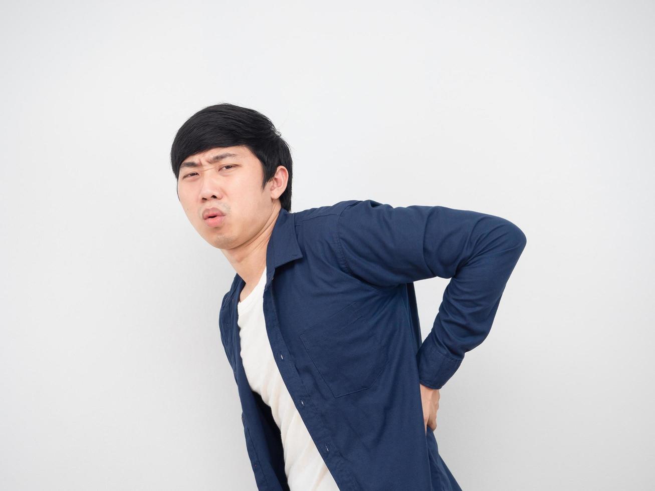 Asian man feeling hurt his waist and back unweel face office syndrome concept portrait white background photo