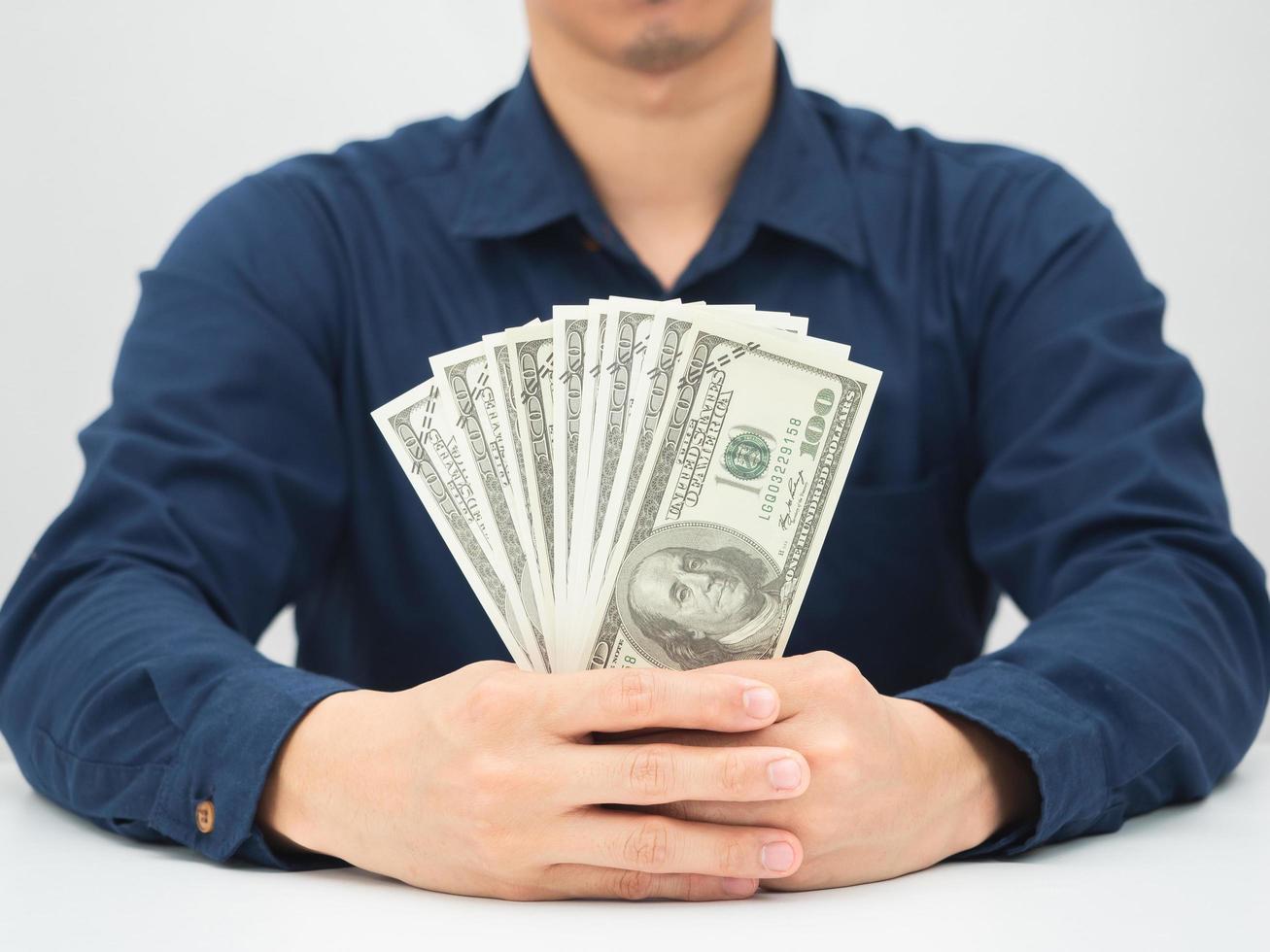 Man hand holding show money dollar on the desk photo