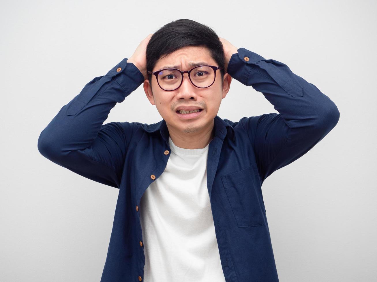 Man wearing glasses feeling afraid something hand touch his head photo