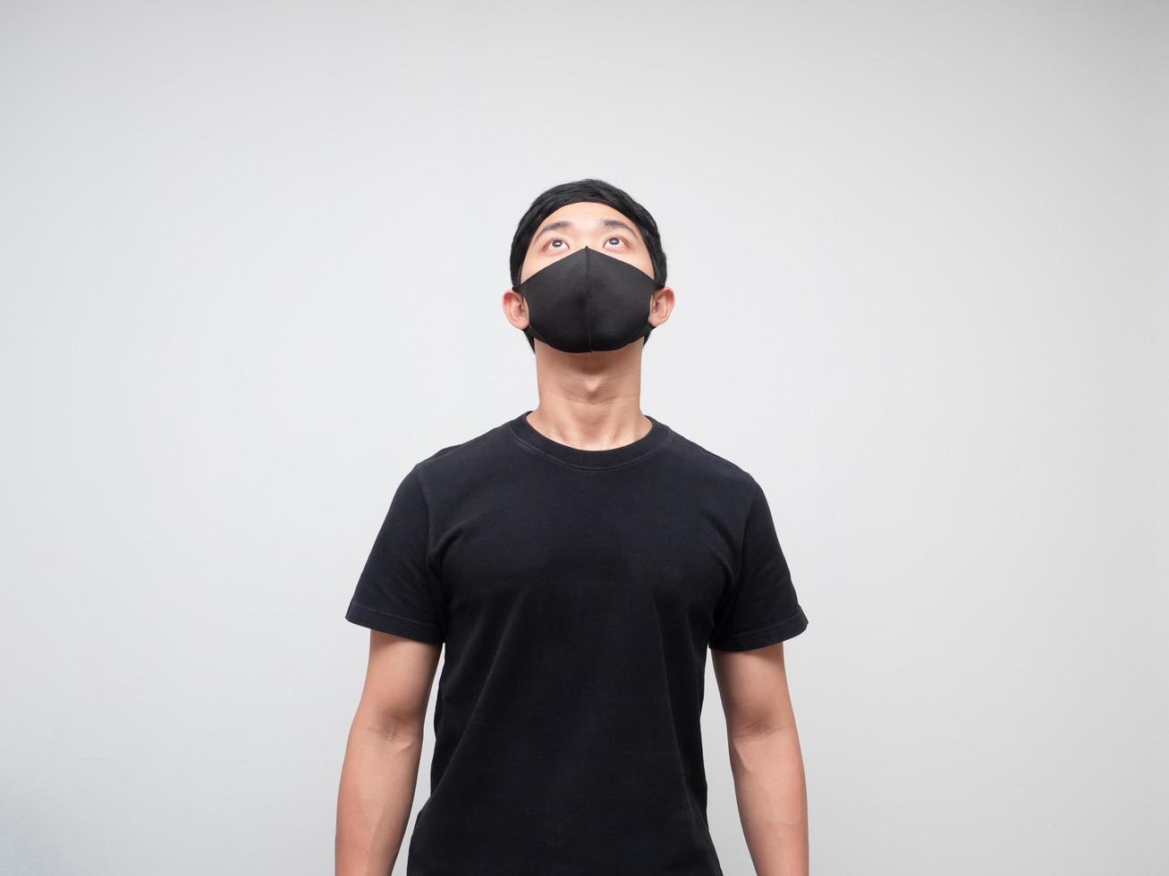Portrait asian man with protect mask looking up to space on white background photo