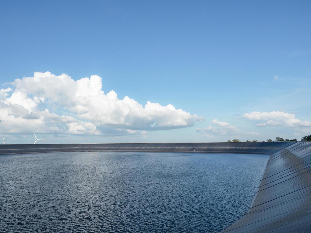 Water in reservoir landscape with cloudy and blue sky,Dam on the mountain and wind generator beautiful view photo