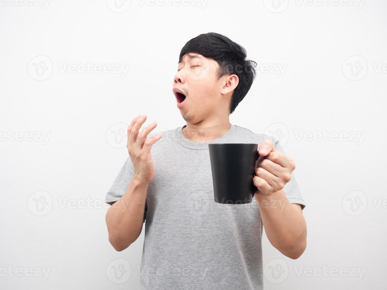 Man holding coffee feeling sleepy gesture yawn white background photo