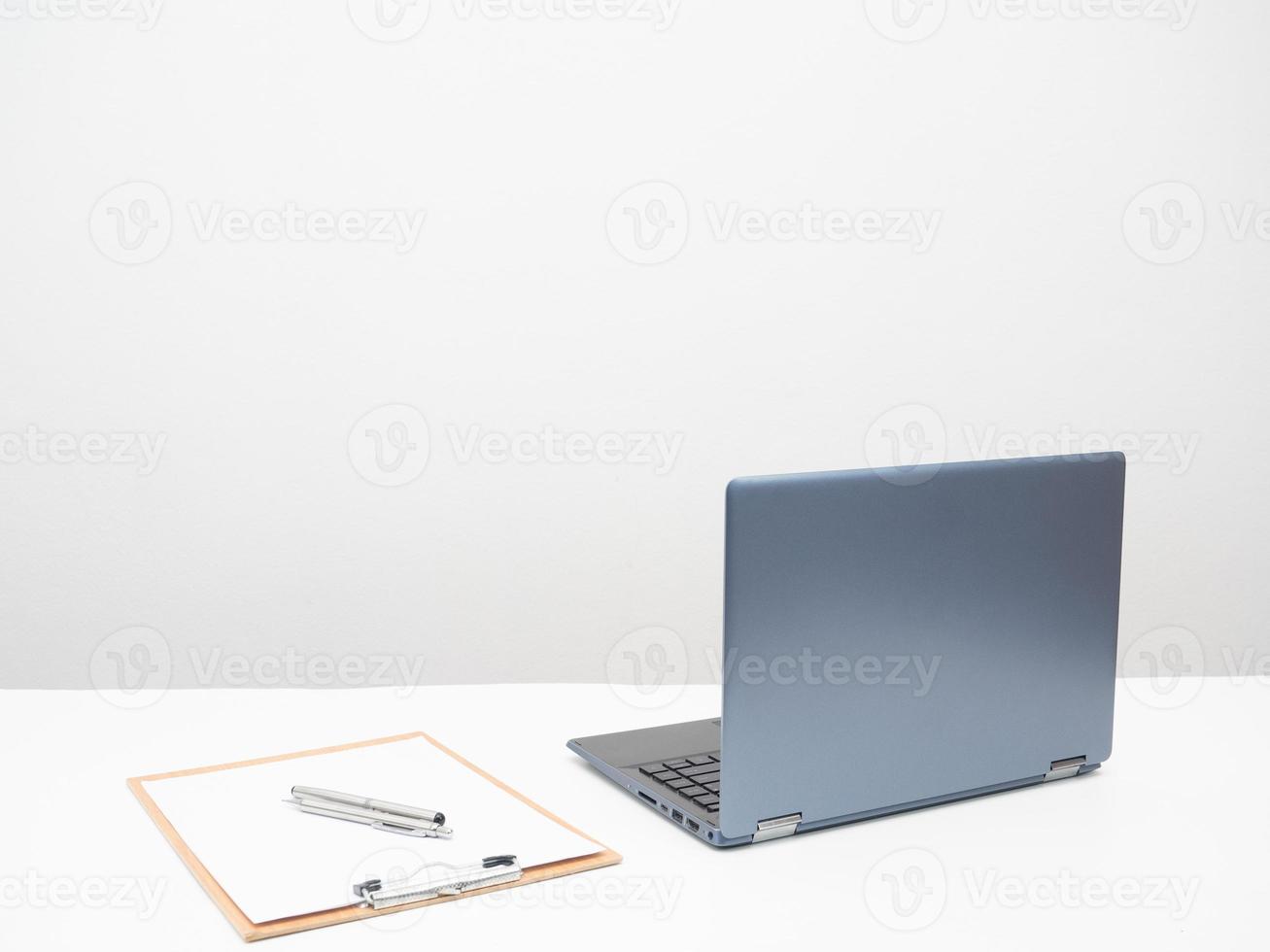 Laptop with document board on the table workplace in the room white background photo