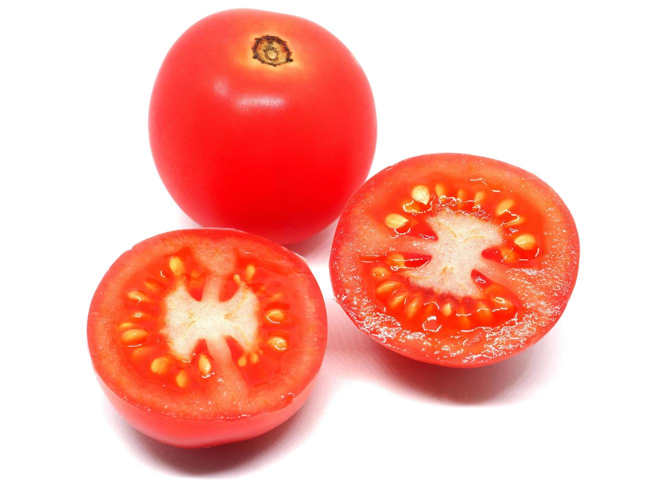 Closeup cut slice plum tomato detail on white isolated photo