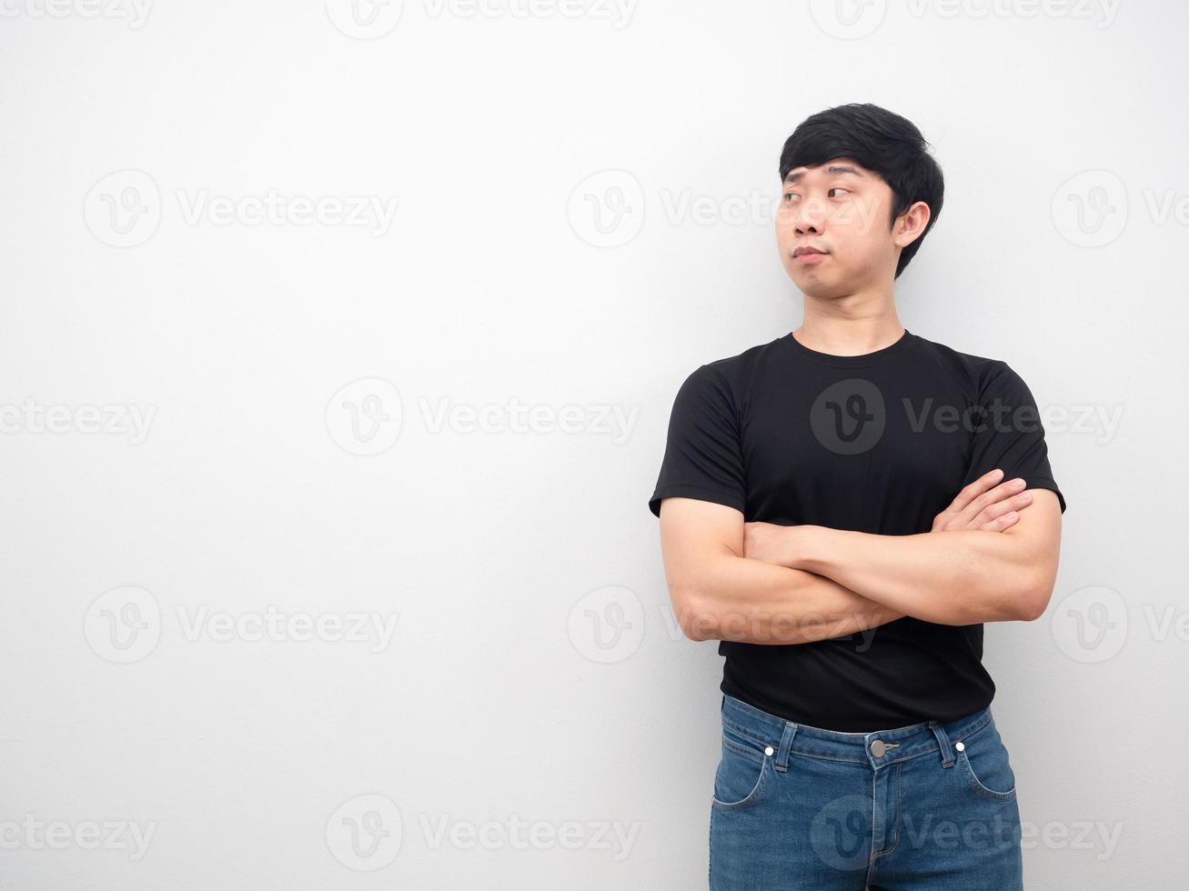 Man black shirt with jeans cross arm looking at copy space photo