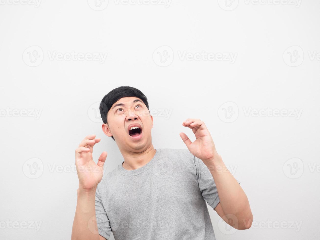 Man feeling shocked looking above white background photo