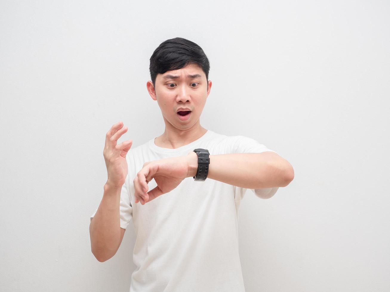 Man look at his watch feeling shocked at face late concept white background photo