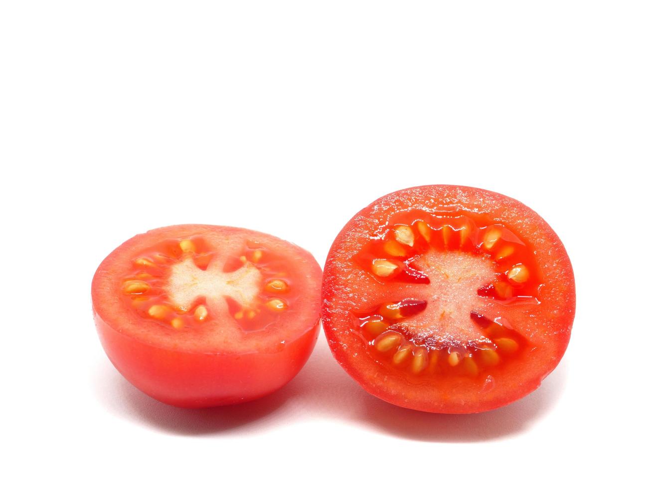 Closeup cut slice plum tomato detail on white isolated photo