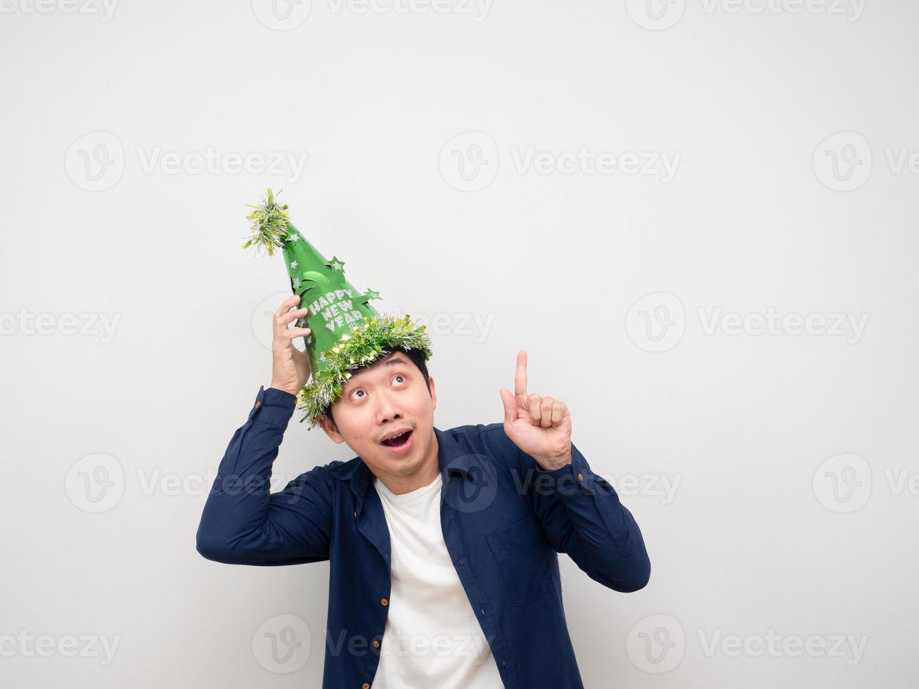 Man wearing green hat feeling happy point finger up at copy space photo