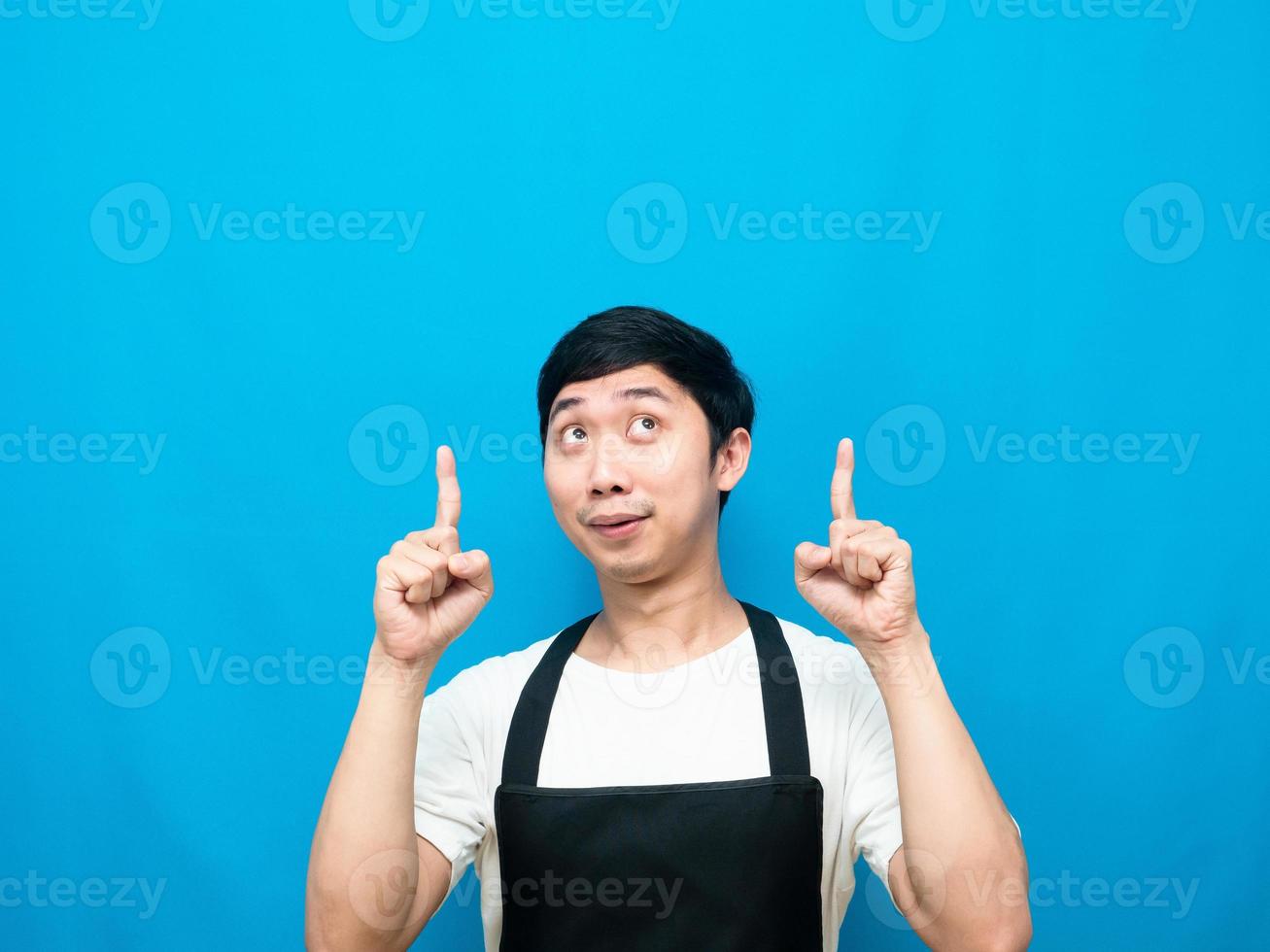 Man apron gesture point finger up at copy space photo