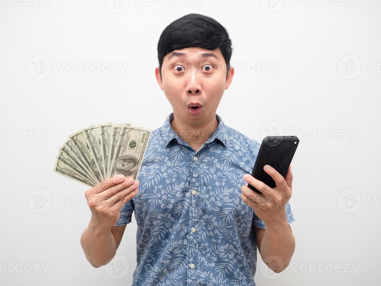 Man blue shirt holding smartphone and a lot of money gesture Amazed photo